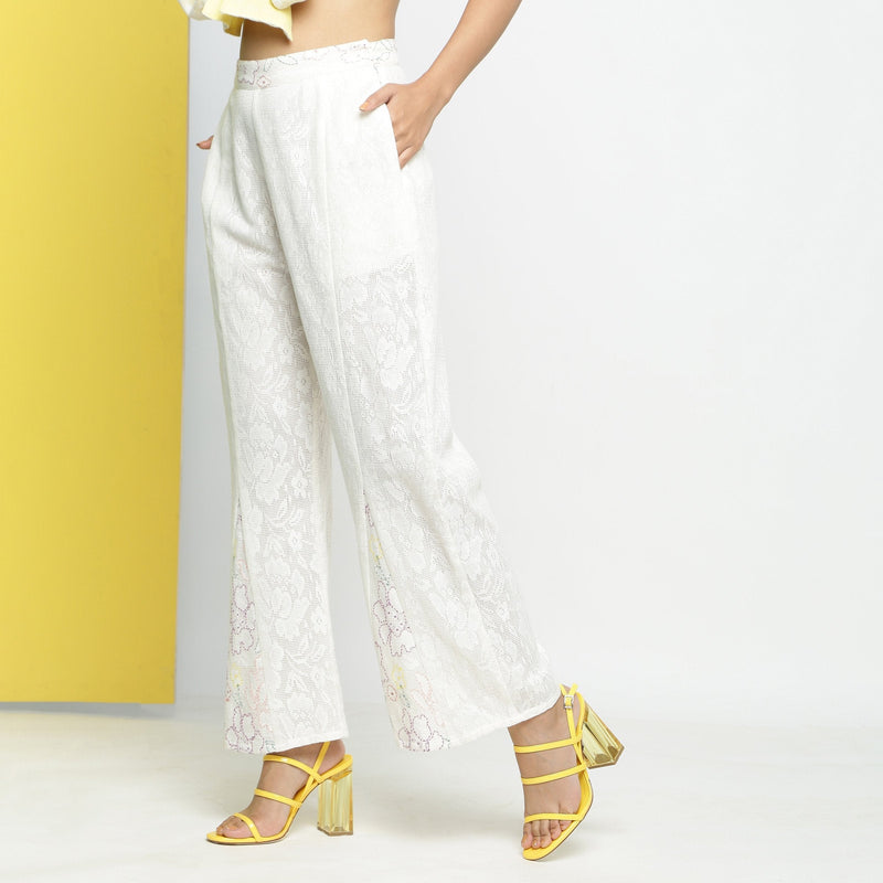 Left View of a Model wearing White Cotton Schiffli Paneled Pant