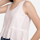 Left Detail of a Model wearing White Round Neck Cotton Peplum Top