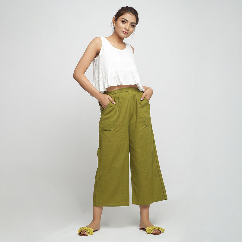 Front View of a Model wearing White Cotton Peplum Top and Green Pant Set