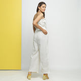 Back View of a Model wearing White Cotton Schiffli Floral Jumpsuit