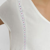 Front Detail of a Model wearing White Organic Cotton Hand Beaded Flared Dress