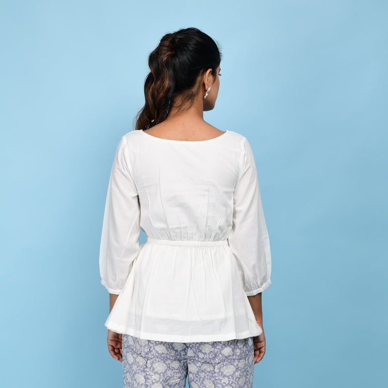 Back View of a Model wearing White Organic Cotton Relaxed Sleeves Peplum Top