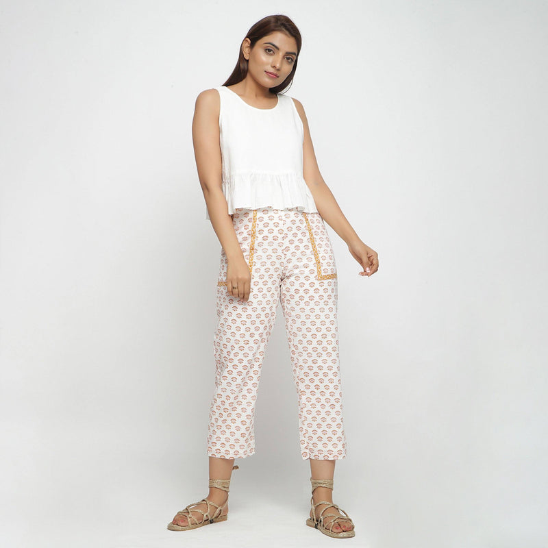 Front View of a Model wearing White Peplum Top and Floral Straight Pant Set