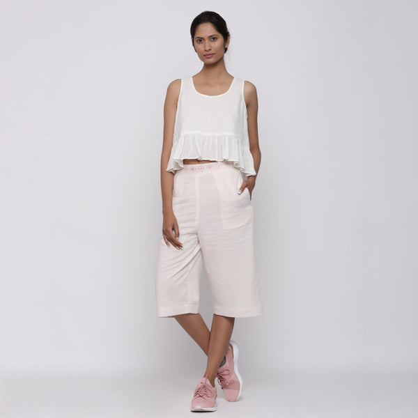 Front View of a Model wearing White Peplum Top and Powder Pink Culottes Set