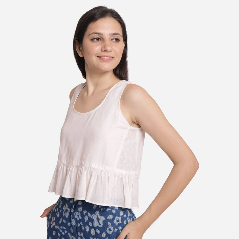 Left View of a Model wearing White Round Neck Cotton Peplum Top