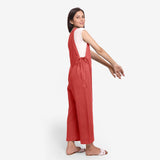 Right View of a Model wearing White Straight Top and Brick Red Jumpsuit Set