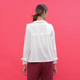 Back View of a Model Wearing White Dobby Ruffled Peasant Blouse Top