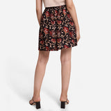 Back View of a Model wearing Black Floral A-Line Cotton Flared Skirt