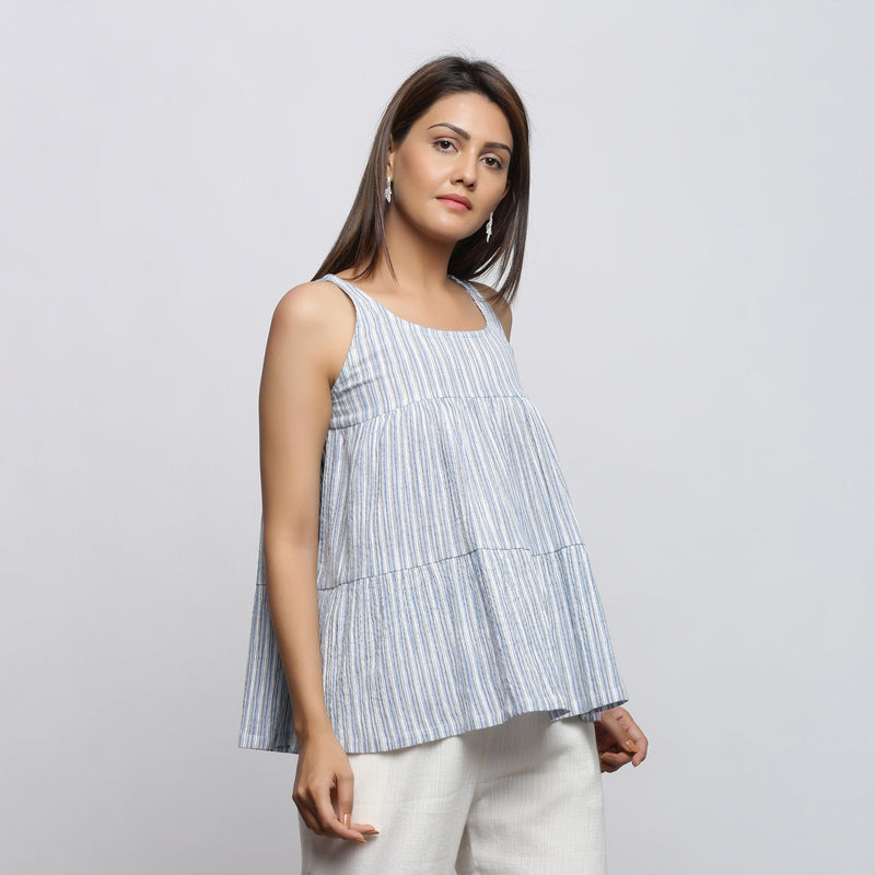Right View of a Model wearing White And Blue Yarn Dyed Flared Top