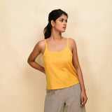 Front View of a Model wearing Yellow 100% Cotton Relaxed Fit Spaghetti Top