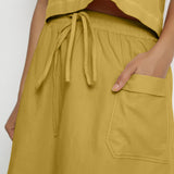 Front Detail of a Model wearing Vegetable-Dyed Light Yellow 100% Cotton Mid-Rise Skirt