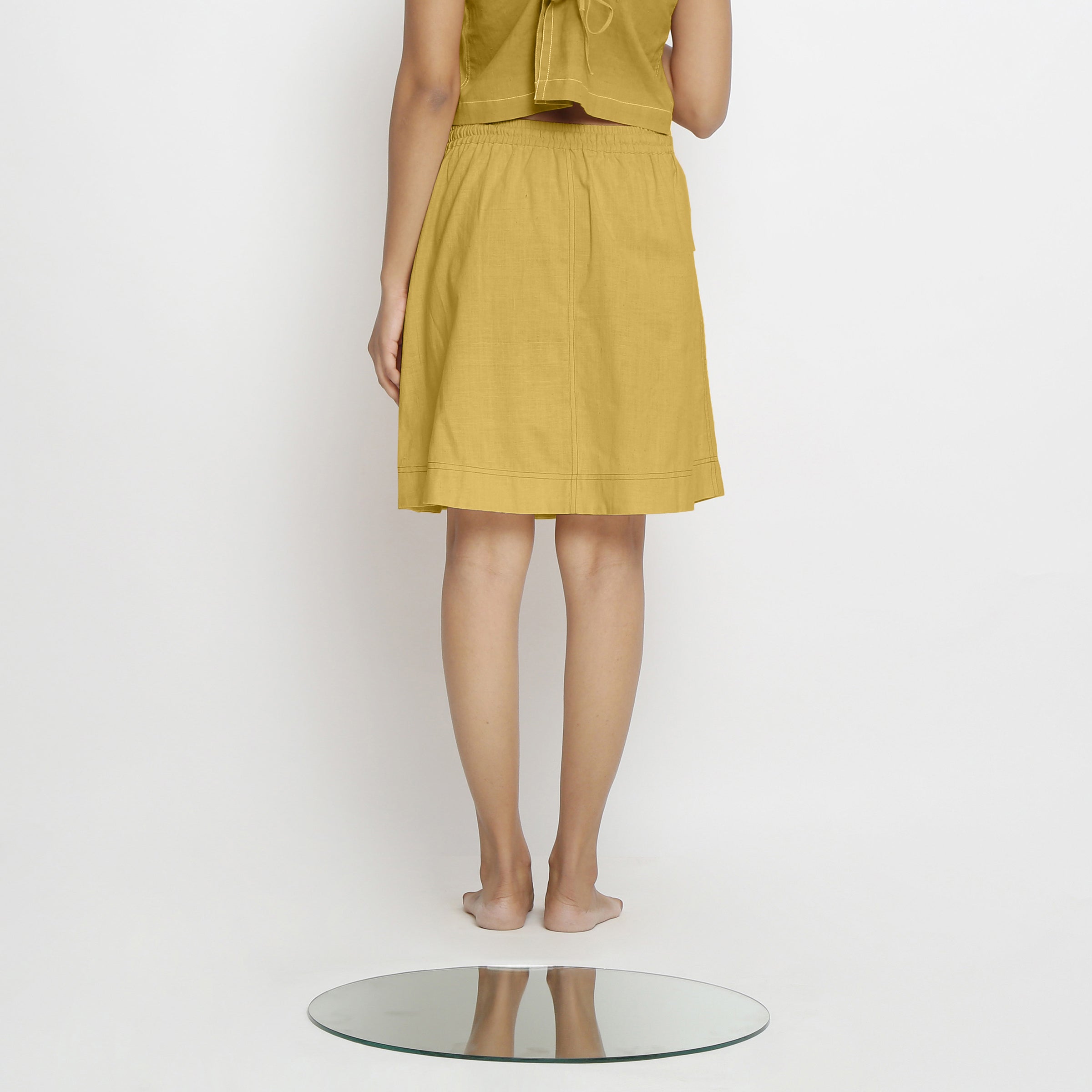 Back View of a Model wearing Vegetable-Dyed Light Yellow 100% Cotton Mid-Rise Skirt