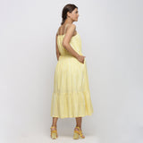 Back View of a Model wearing Yellow Tie and Dye Strap Tiered Dress
