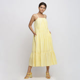 Front View of a Model wearing Yellow Tie and Dye Strap Tiered Dress