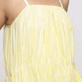 Front Detail of a Model wearing Yellow Tie and Dye Strap Tiered Dress