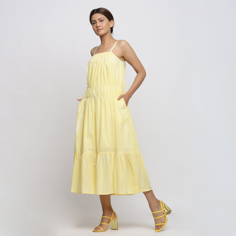 Left View of a Model wearing Yellow Tie and Dye Strap Tiered Dress